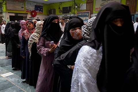 Voters queue up to cast their vote in Delhi